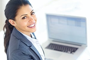 professional woman in front of an open laptop