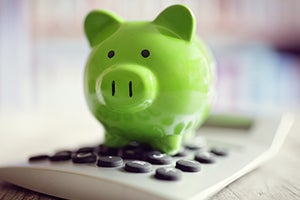 piggy bank on top of calculator