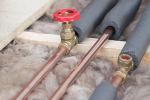 Copper water pipes being installed in a roof space.