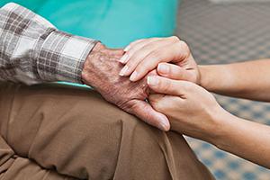 Holding elderly persons hand