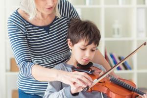 Instructor giving violin lesson