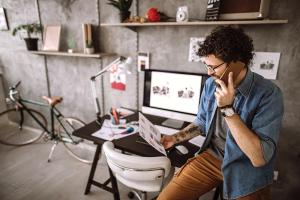 Man on phone working in home studio